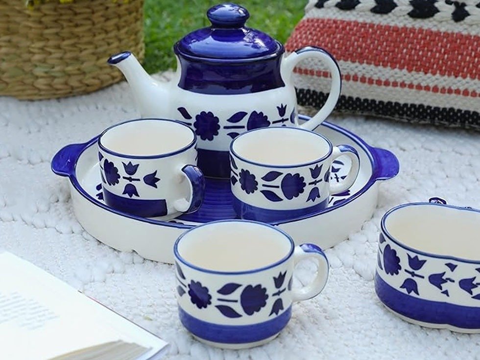 Best buy, efdbestbuy, www.efdbestbuy.com, efd best buy, efd bestbuy, efd-bestbuy, efd-best-buy, shopping advisor, efd shopping advisor, efd best buy shopping advisor, consult before buy, efd consult before buy, efd best buy consult before buy, Add elegance to your tea-time moments with this beautifully crafted Tea Cup Set with Kettle & Serving Tray, featuring a stunning handpainted blue floral design that enhances your dining and serving experience. Made from high-quality ceramic, this 6-piece tea set includes 4 tea cups (150ml each), 1 spacious kettle (700ml), and 1 matching serving tray, making it perfect for serving guests, family gatherings, and special occasions. The microwave-safe ceramic material ensures convenience for reheating while maintaining durability and long-lasting shine. Designed for both everyday use and festive celebrations, this floral ceramic tea set blends traditional charm with modern functionality. Ideal as a thoughtful gift for housewarming, weddings, anniversaries, birthdays, or festive gifting, this elegant tea cup and kettle set is perfect for those searching for a premium ceramic tea set, handpainted tea cups, designer tea serving set, microwave-safe tea set, or stylish gifting option that combines beauty and practicality.